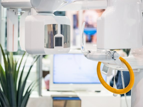 Advanced dental scanning device with computer screen in background