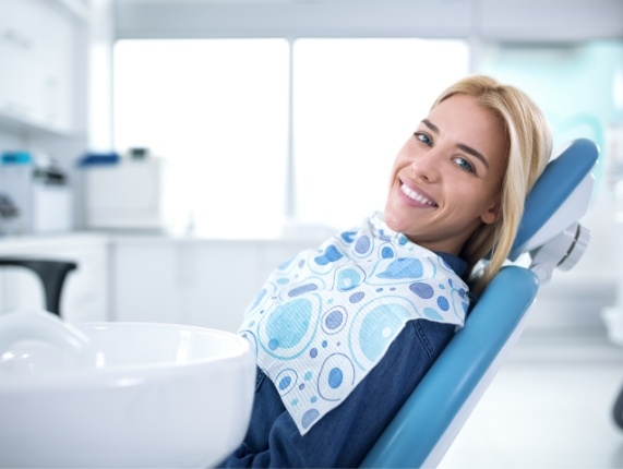 Blonde woman smiling while visiting West Orange dental office