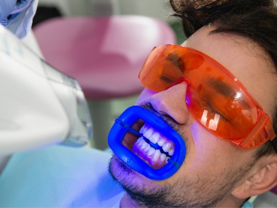 Man getting teeth whitening from cosmetic dentist