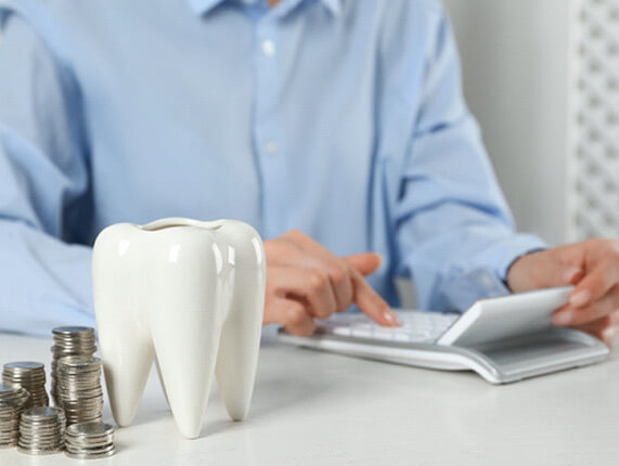 a patient calculating the cost of wisdom tooth extractions
