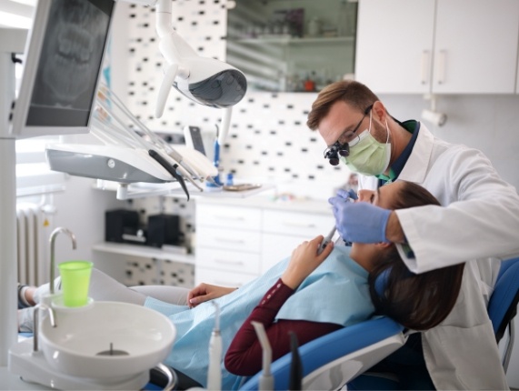 Woman receiving dental exam from family dentist in West Orange