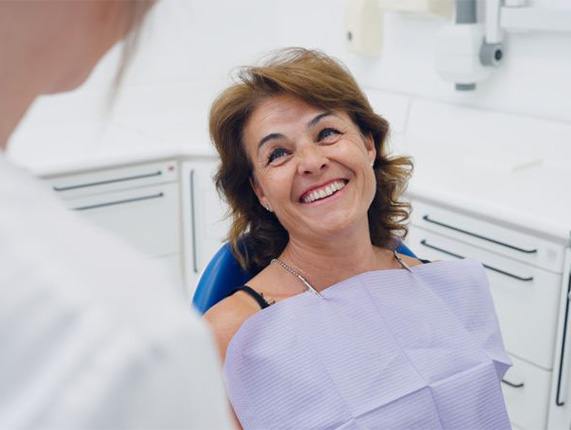 Happy patient looking up at her dentist.