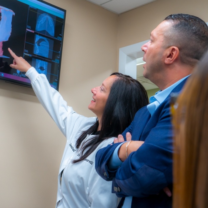 West Orange New Jersey dentists Doctors Med Dawoud and Paula Gencarelli looking at impressions of teeth on computer screen