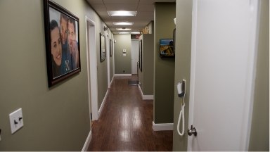 Hallway in dental office with framed photos on the walls