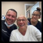 West Orange dentist and assistant taking selfie with dental patient