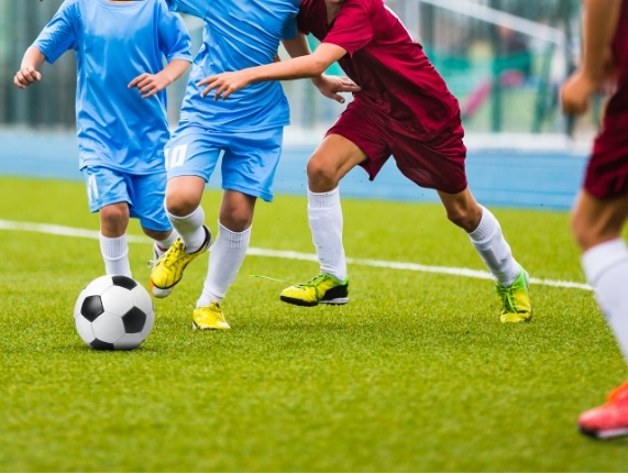 Close up of several people playing soccer