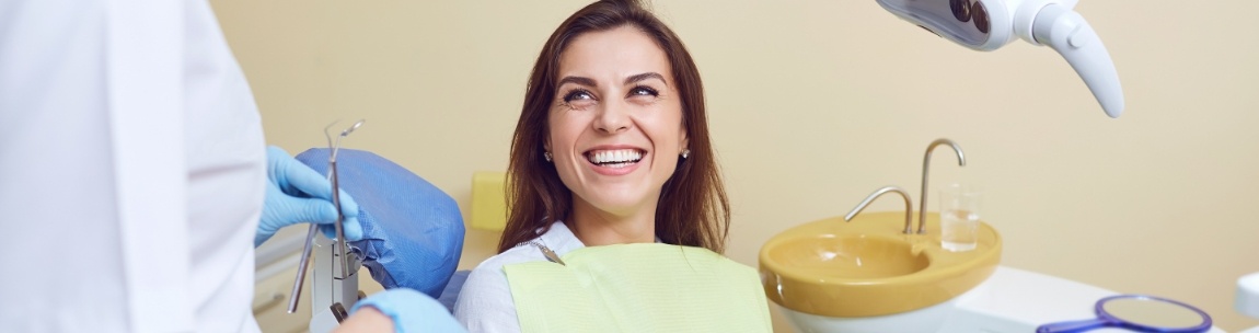Smiling woman talking to her dentist about dental services in West Orange