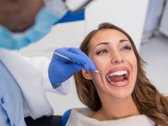 WOman opening her mouth for preventive dental checkup