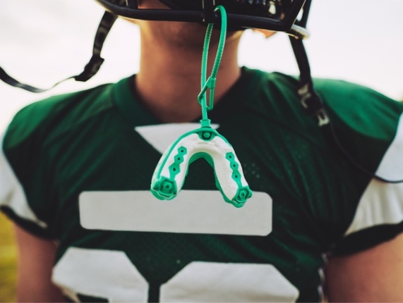 Sports mouthguard hanging from football helmet