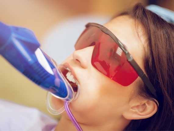 Young girl getting fluoride treatment in dental office