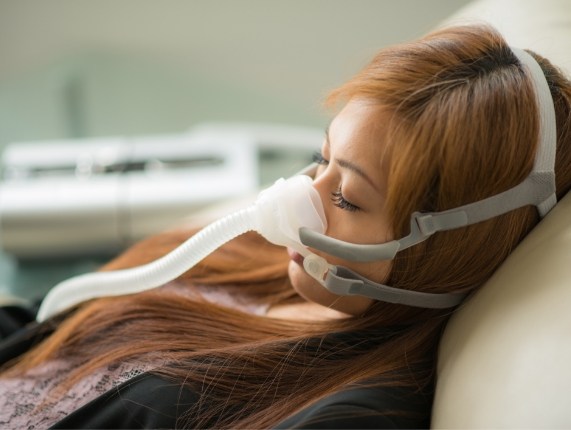Sleeping woman wearing mask for C P A P machine