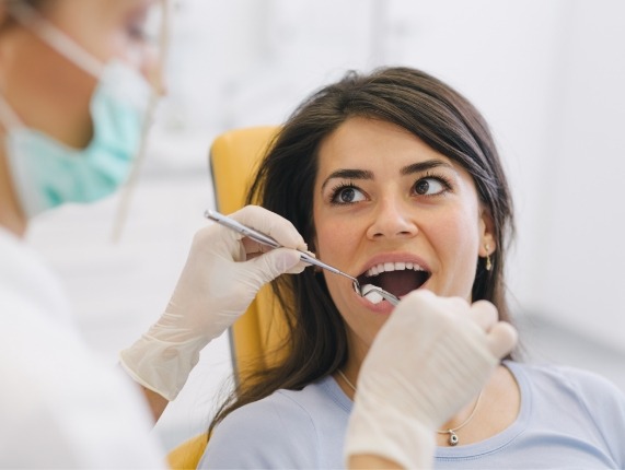 WOman having her mouth examined by a dentist