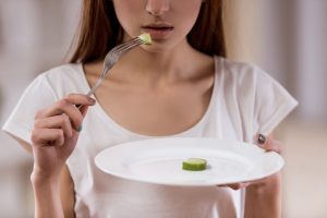 very thin woman eating food