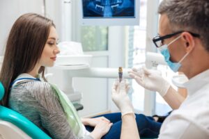 Woman learning how she can better care for her dental implants