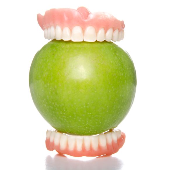Dentures biting an apple