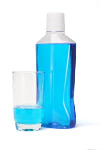 bottle of blue mouthwash white top