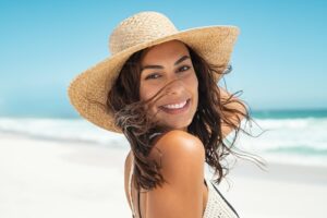Woman smiling with a wide-brimmed hat