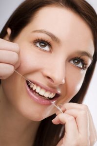 woman flossing her teeth