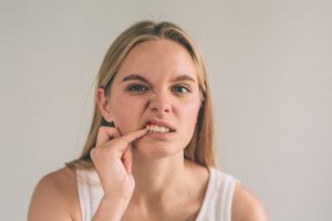 woman experiencing oral health problems