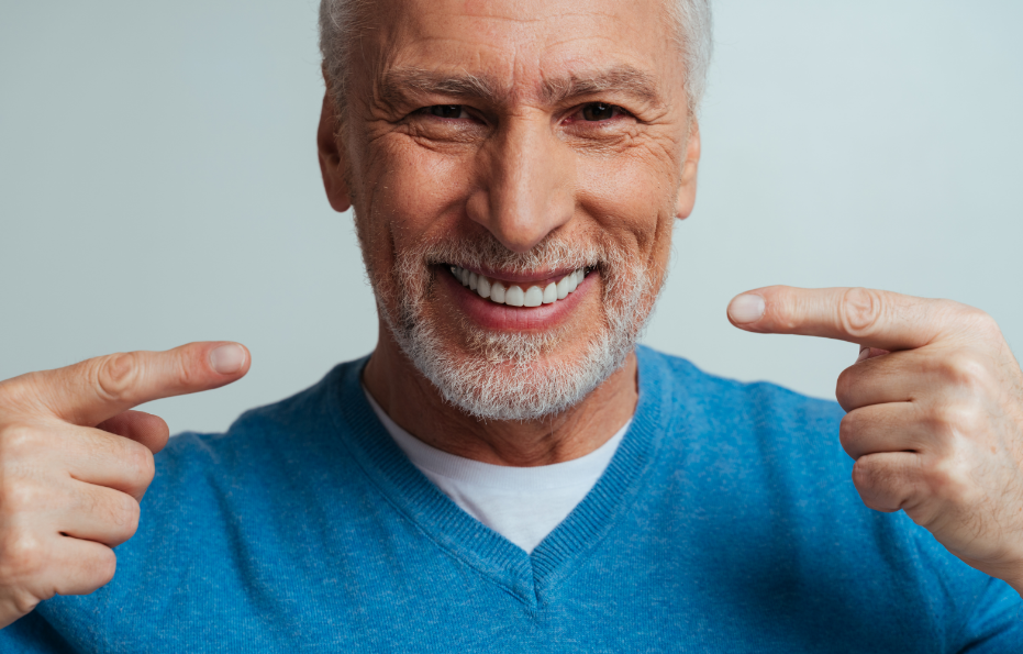 Man pointing at dentures